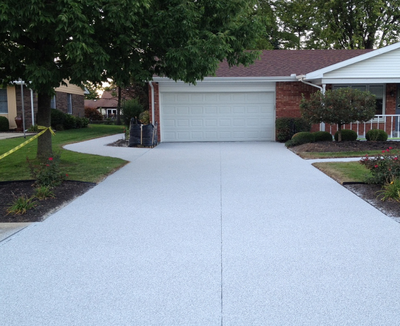 Plain gray textured concrete driveway.