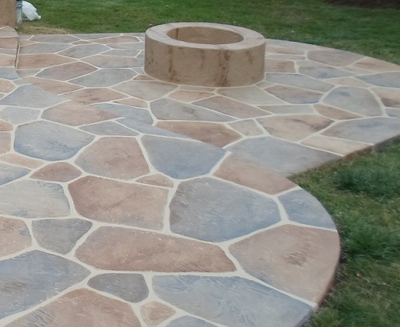 Multi-colored sandstoned backyard patio, with a built in fire pit in Connecticut.