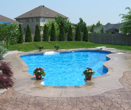Pool deck with a simple concrete edging and a stone stamped outer lay.