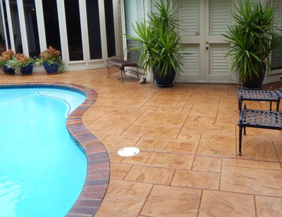 Terracotta colored stamped concrete pool deck